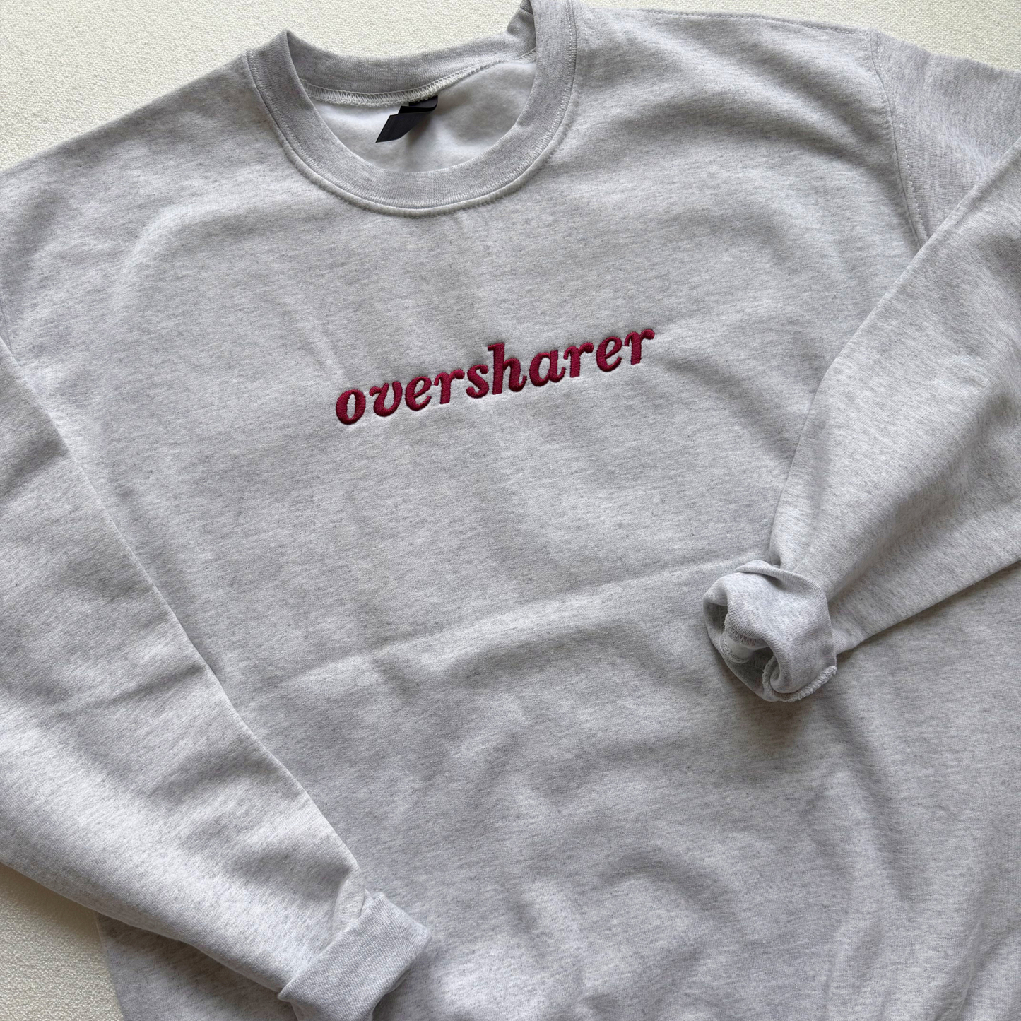 Oversharer — Embroidered Gildan Sweatshirt