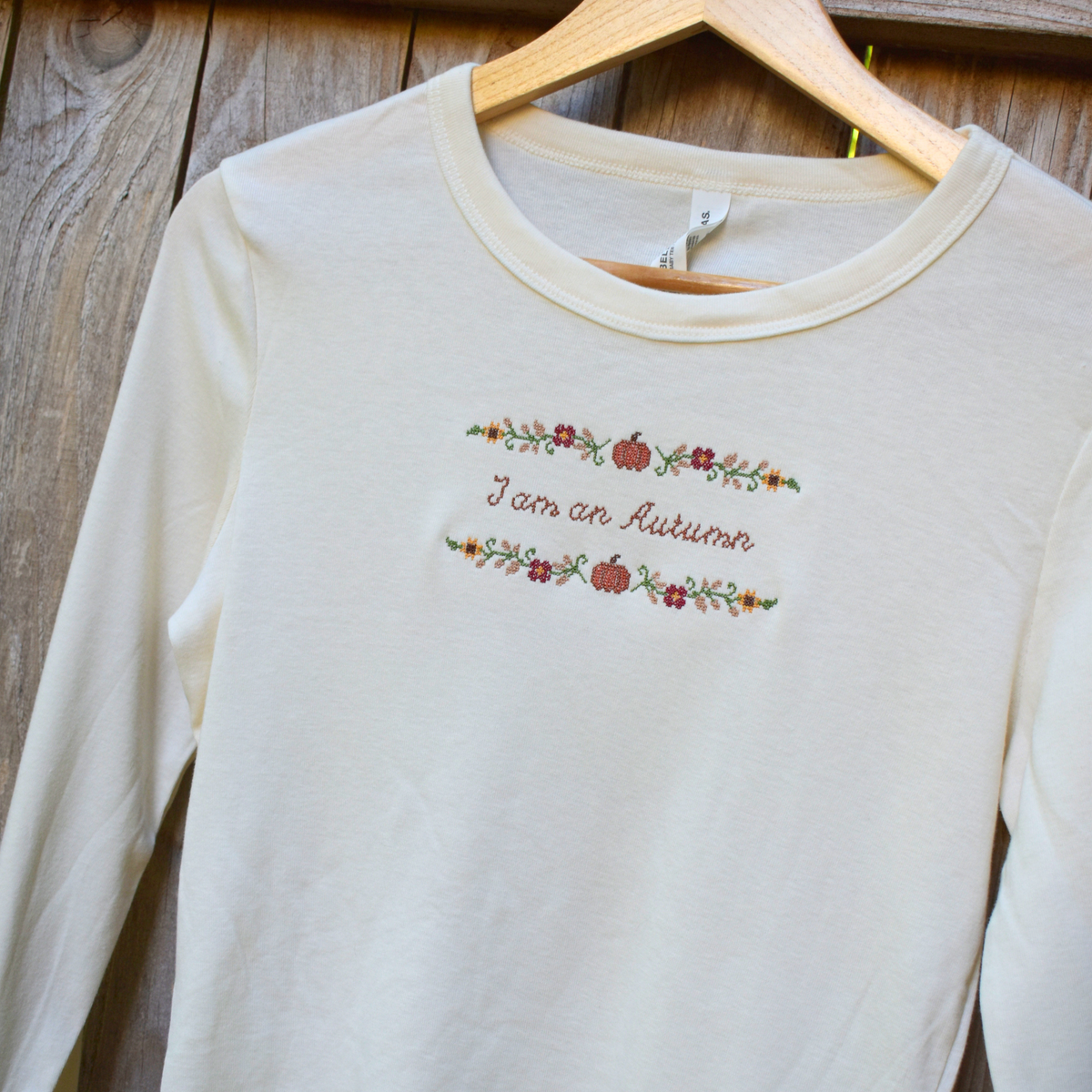 I am an Autumn — Embroidered Bella + Canvas Long Sleeve Baby Tee