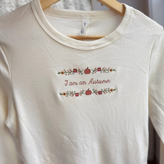 I am an Autumn — Embroidered Bella + Canvas Long Sleeve Baby Tee